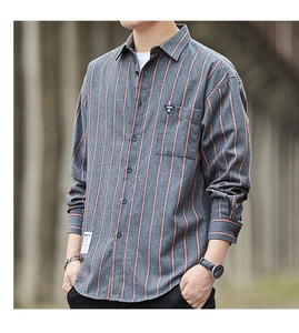 Detail of dark gray striped casual shirt showing textured fabric and fashion chest label