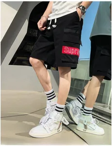 Detail of men's cargo shorts featuring a side pocket and red woven Supra brand label