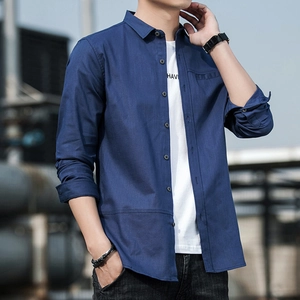 Men's navy blue long sleeve linen shirt styled over a white tee with black jeans