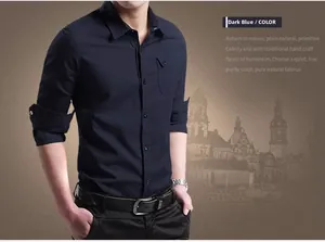 Detail of slim-fit cotton shirt in dark blue featuring a chest pocket and rolled cuffs