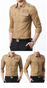 Detail of khaki military cotton shirt featuring buttoned chest pockets and embroidered badges