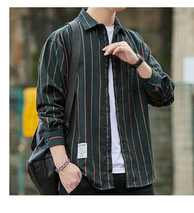 Close-up of green striped long sleeve shirt texture and white woven label on the hem