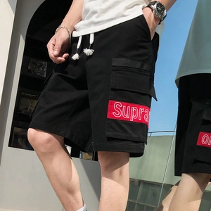 Men's loose black cargo shorts with side flap pockets and elastic drawstring waist