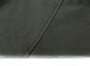 Detail view of smooth double-needle stitching on dark grey-green cotton shirt fabric