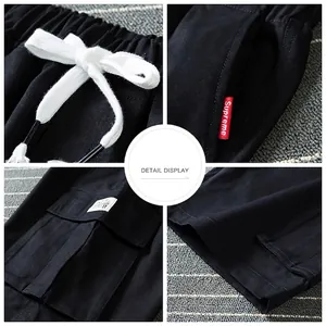 Men's loose black cargo shorts with elastic drawstring waist and side flap pockets