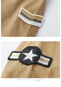 Detail of high-quality military style embroidery patches on khaki cotton shirt sleeve
