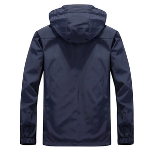 Back view of a navy blue hooded windbreaker jacket with elastic cuffs in a loose fit