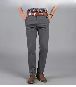 Detailed close-up of men's dark grey straight leg dress pants with brown leather belt
