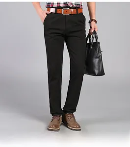 Detail of men's straight-leg business trousers in black with leather belt and briefcase