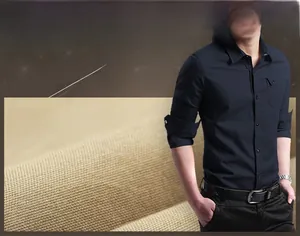 Detail view of navy blue long sleeve cotton shirt showing fabric texture and pocket