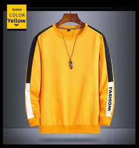 Detail of ginger yellow sweatshirt with black and white sleeve stripes and fashion lettering