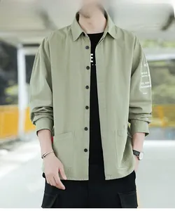 Close-up of olive green cargo shirt with white sleeve lettering and workwear details