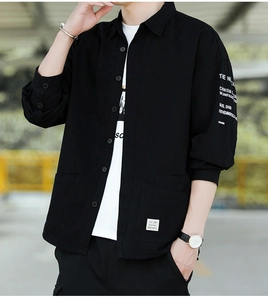 Close-up of black cotton utility shirt with white sleeve print and large pockets