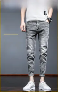 Slim fit men's light grey stretch denim jeans with tapered leg and casual street style