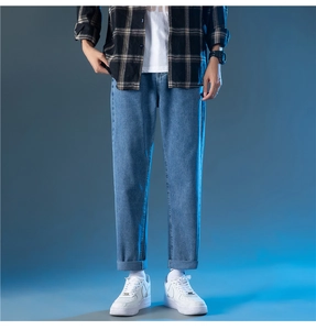 Détails de jean bleu clair droit pour hommes avec ourlets larges et texture denim
