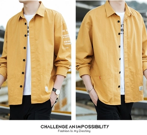 Detailed view of ginger yellow cotton utility shirt with pocket and letter sleeve print