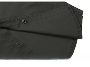 Detailed macro view of the curved shirt hem and stitching on twill fabric