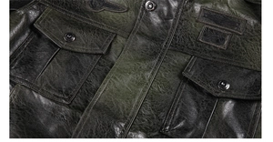 Detail of washed PU leather jacket with vintage texture and embroidered badge decoration