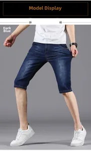 Detail view of men's dark blue denim shorts featuring yellow contrast stitching accents