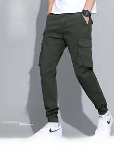 Detail shot of men's cargo pants showing side flap pockets and military green cotton fabric