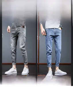Detail showing rolled cuffs and whiskered texture of slim fit men's stretch jeans