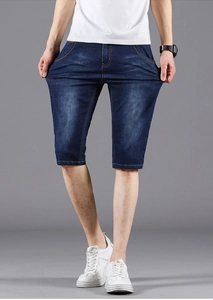 Detail of blue stretch denim shorts showing high elasticity fabric and yellow stitching