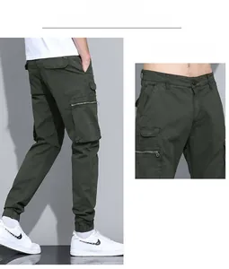Detailed view of army green cargo pants with metal zipper pockets and ribbed cuffs