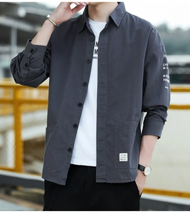 Detail of grey cotton work shirt featuring chest pocket logo and sleeve letter printing