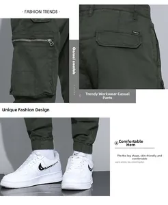 Detail of dark green cargo pants featuring side zipper pockets and cotton fabric texture