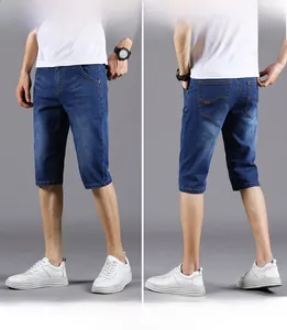 Detailed front and back view of dark blue denim shorts with whiskered wash finish