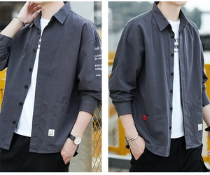 Detail view of cotton workwear shirt featuring chest pockets and sleeve typography