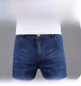 Detailed close-up of dark blue men's straight denim shorts with yellow stitching