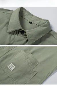 Detailed close-up of cotton work shirt collar and pocket with printed white label