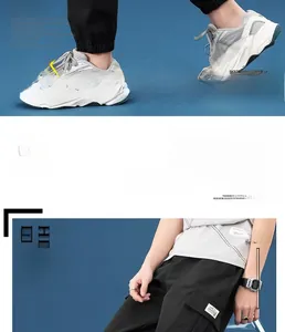 Detail of men's black cargo pants with side pockets and stylish white t-shirt outfit