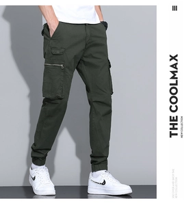 Detailed close-up of army green cargo joggers featuring side flap and zipper pockets