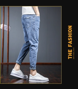 Detail shot of light blue slim fit denim jeans with premium denim texture and pocket tag
