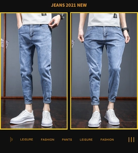 Detailed close-up of light blue slim fit denim pants showing stretch fabric and washed texture