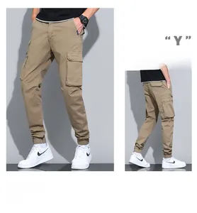 Detail of khaki cargo joggers showing multi-pocket design and elastic ribbed cuffs