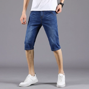 Men's slim fit dark blue denim shorts with vintage wash and whiskers on grey background