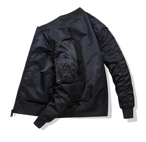 Detail of black bomber jacket featuring ribbed collar and utility sleeve zipper pocket