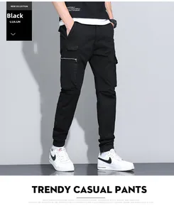 Detail of black cotton cargo pants with side pockets and adjustable elastic drawstring waist