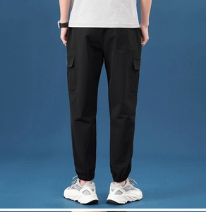 Rear view of men's black cargo pants with elastic cuffs and tactical utility pockets
