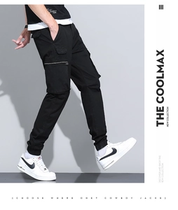 Detail of black cargo pants featuring side zipper pockets and tapered ankle cuffs