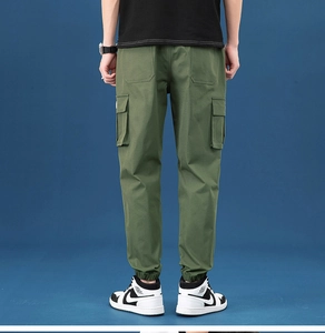 Detailed back view of army green cargo pants featuring large side pockets and ribbed cuffs