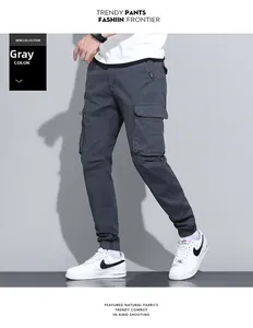 Detailed view of dark grey cotton cargo pants featuring functional side pockets and ribbed cuffs