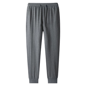Loose dark gray men's jogger pants with elastic drawstring waist and ribbed cuffs