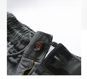 Detail view of cargo pants elastic waist with button and high quality metal zipper