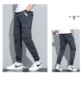 Detail of grey jogger cargo pants featuring multi-pocket design and ribbed cuffs for men