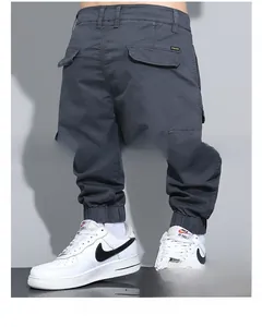 Detail of men's cargo pants showing the rear flap pocket and elastic cuffs design