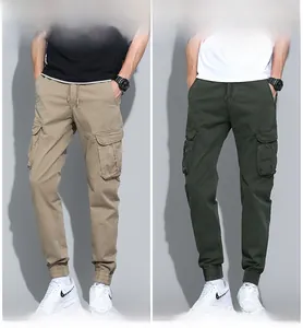Detail of khaki and army green cargo pants with drawstring waist and large side pockets